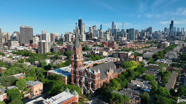 St Michael Catholic Church in Old Town Chicago, Illinois. Aerial establishing shot in summer with skyline in distance.