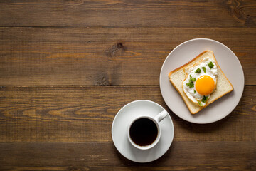 Fried eggs on toast bread with coffee - fast breakfast background