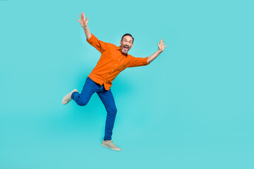 Full body length photo of funky jumping carefree overjoyed businessman positive crazy mood isolated...