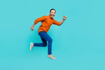 Fototapeta na wymiar Full size body photo of running hurry funny jumper businessman senior achieve more goals successful isolated on blue color background