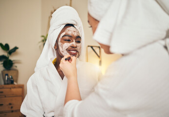 Skincare, facial and women friends in a bedroom with mask, application and spa day bonding in their home. Beauty, cream and people with self care sleepover, lotion or cosmetic wellness on the weekend