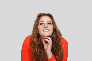Positive redhead woman looking at camera and smiling on white background