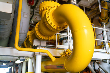 Small yellow valves placed next to each other control the flow of outdoor oil pipelines.