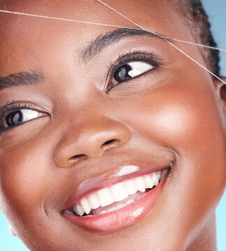Thread, eyebrow plucking and beauty of a woman with dermatology, natural makeup and smile. Face of an African person on a studio background with cosmetics, hair removal and facial glow or self care