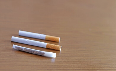 Cigarettes on a wooden table. Selective focus. Space for text
