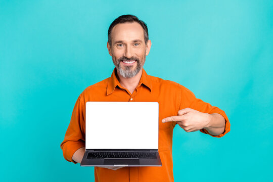 Photo of cheerful marketing brand manager senior businessman point finger laptop screen website isolated on aquamarine color background