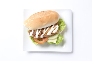 speciality grilled bbq chicken chop burger bun with cheese, vegetables and salad sauce breakfast in plate on white background western chef appetiser halal bakery food restaurant pastry menu for cafe