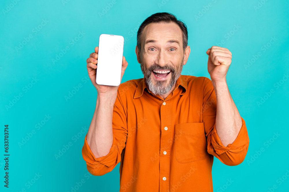 Sticker Photo of retired businessman get his salary ebanking finance app website phone screen celebrate fist up isolated on blue color background