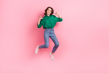 Fototapeta na wymiar Full size portrait of carefree excited girl jumping point fingers self herself empty space ad isolated on pink color background