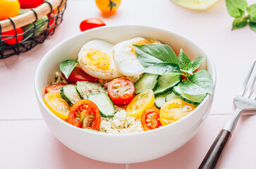 Savory hight protein breakfast bowl with cottage cheese, cucumber, boiled egg, cherry tomatoes and basil.