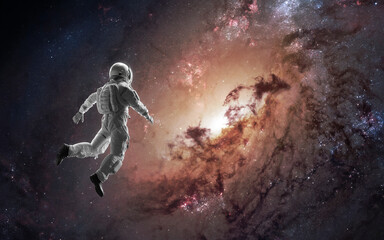 Obraz na płótnie Canvas 3D illustration of giant spiral galaxy, astronaut looking at it. Black hole. 5K sci-fi visualization. Elements of image provided by Nasa