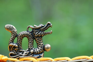 Dragon figurine with Chinese coins. A religious symbol.