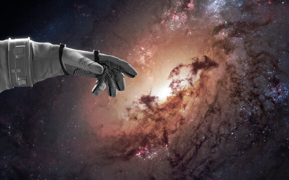 3D illustration of giant spiral galaxy, astronaut hand. Black hole. 5K sci-fi visualization. Elements of image provided by Nasa