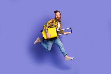 Full length photo of cheerful guy wear trendy clothes running airport hurrying registration resort abroad isolated purple color background