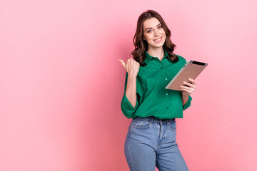 Photo of pretty shiny lady wear green shirt working modern gadget thumb empty space isolated pink color background