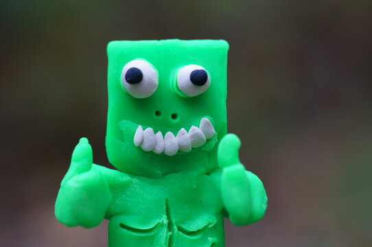 Funny monster made of green plasticine.