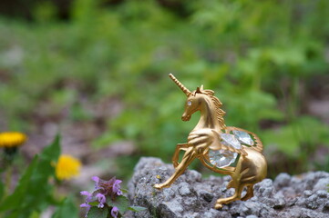 Metal unicorn figurine on a natural background. Talismans and amulets of Feng shui. A mythological character. Horoscope.