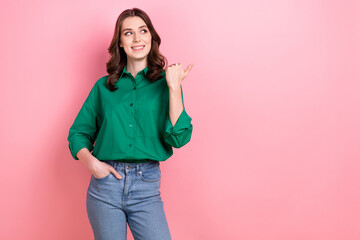 Photo of pretty dreamy lady wear green shirt looking pointing thumb empty space isolated pink color background