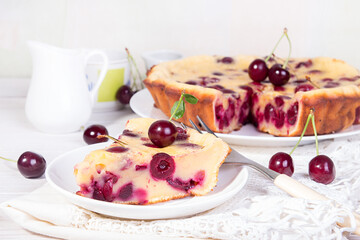 Cake with sweet cherries on a plate