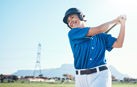 Baseball, bat and swing of a woman outdoor on a pitch for sports, performance and competition. Professional athlete or softball player with a smile, space and ready for game, training or exercise