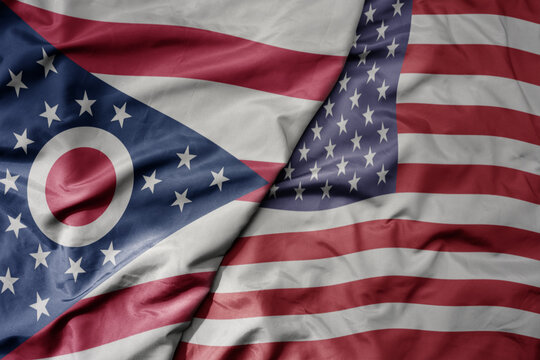big waving colorful national flag of united states of america and flag of ohio state .