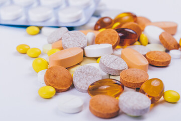 Pills and tablets on white background.  Tablets in blisters. Various treatments mixed. Variety of pills and medication. Close up. Macro. Medical concept.