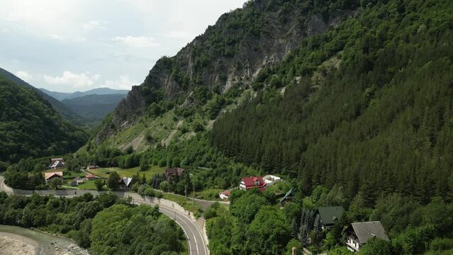 Drone dolley tilt shot of a steep mountain side in Lepsa Romania on a cloudy day