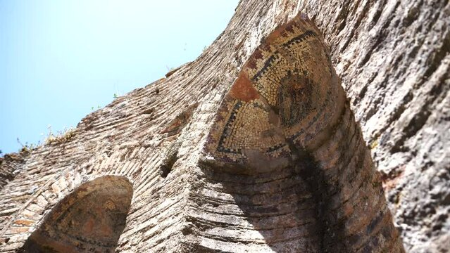 Butrint, Albania, ceramic mosaics in arched windows of an ancient stone building