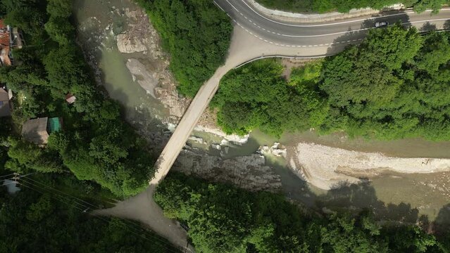 Top down drone lifting shot of a bridge over the Putna river in Romania
