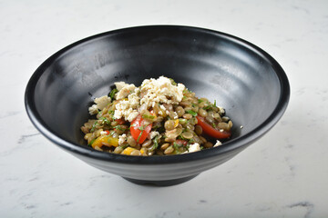 trio quinoa grain salad bowl with avocado, tomato, pea bean, carrot and brown rice in black bowl on white marble table background chef cook healthy poke bowl halal vegan food menu