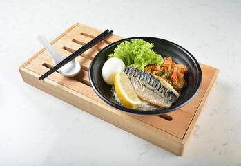 bbq grill Korean Saba fresh fish seafood with lemon, boiled egg, kimchi and Japanese rice in black...