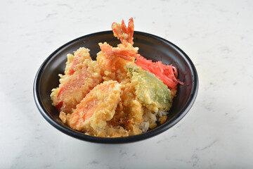 japanese deep fried crispy tempura prawn and vegetables rice in black bowl on wood tray white marble table background chef cook healthy poke bowl halal vegan food menu for cafe