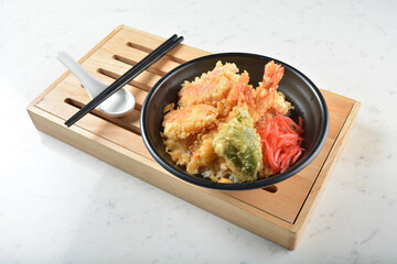 japanese deep fried crispy tempura prawn and vegetables rice in black bowl on wood tray white marble table background chef cook healthy poke bowl halal vegan food menu for cafe