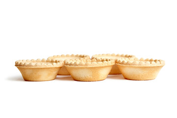 Unfilled tartlet shells isolated on white background. Five crispy mini tart shells closeup. Empty tartlet cups ready for filling