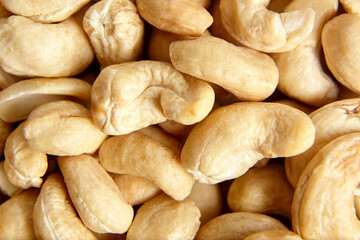 Cashew nut heap food texture background, macro shot. natural cashew heap, top view