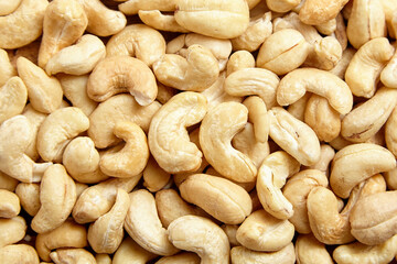 Cashew nut heap food texture background. cashew kernels, a delight, top view