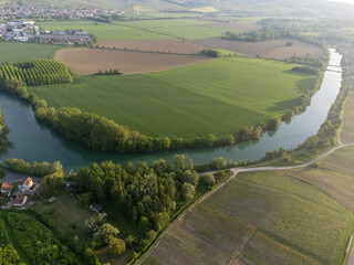 Panoramic aerial view on green premier cru champagne vineyards and fields near village Hautvillers...