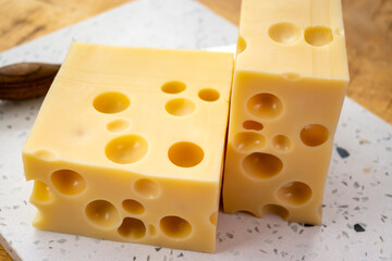 Cheese collection, french hard cheese with holes emmentaler close up