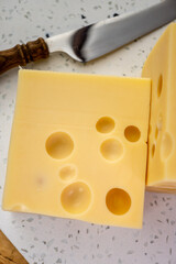 Cheese collection, french hard cheese with holes emmentaler close up