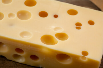 Cheese collection, french hard cheese with holes emmentaler close up