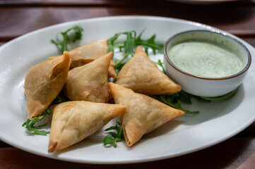 Traditional Middle East snack fried stuffed samosa pie with vegetables served with mint sauce