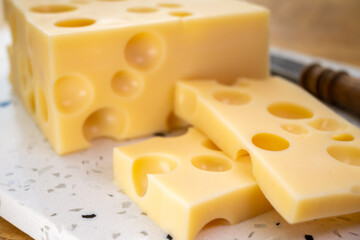 Cheese collection, french hard cheese with holes emmentaler close up