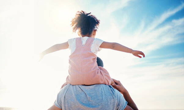 Child On Father Shoulders, Beach And Family With Love, Travel And Back View With Freedom And Fun Together Outdoor. Nature, Adventure With Man And Young Girl Bond On Tropical Holiday And Sunshine