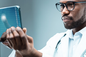 Black doctor, high-tech tablet, bioinformatics, telemedicine