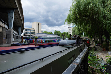 London - 05 29 2022: Foreground houseboat roofs moored near Stone Wharf park in the background Paddington Basin