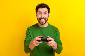 Photo of addicted gamer young guy brunet holding wireless joystick new console playstation 5 advert...