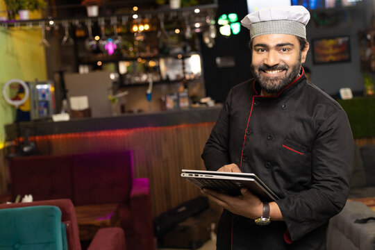 Waiter using tablet at restaurant
