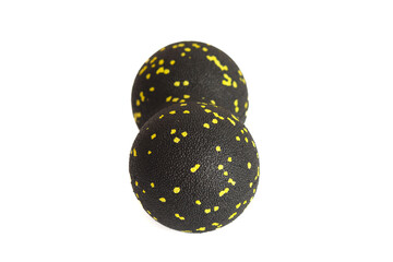 Black double ball or peanut ball massager with yellow dots isolated on a white background. Fitness equipment. Concept of myofascial release.