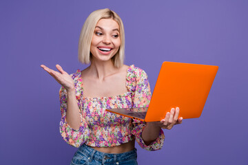 Photo of cute excited lady wear flower print top reading twitter telegram facebook mails isolated...