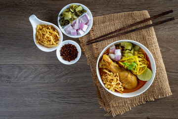 Khao Soi Kai, Thai Noodles Khao Soi Chicken  with seasoning served on table
